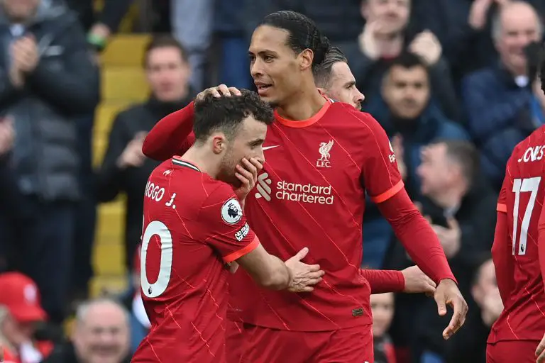 Liverpool's Portuguese striker Diogo Jota (L) celebrates with Virgil van Dijk after scoring.