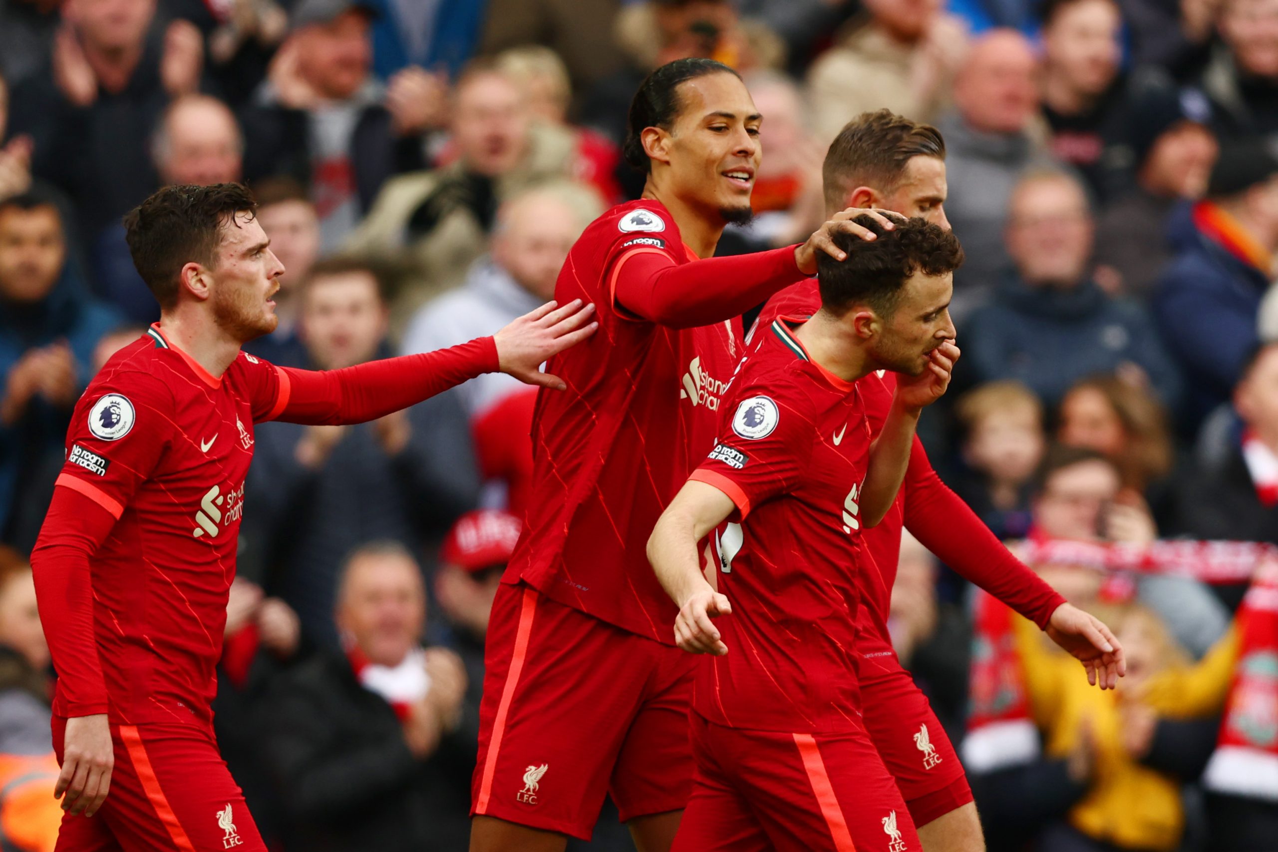 Diogo Jota of Liverpool celebrates with teammates (L-R) Andrew Robertson, Virgil van Dijk and Jordan Henderson.