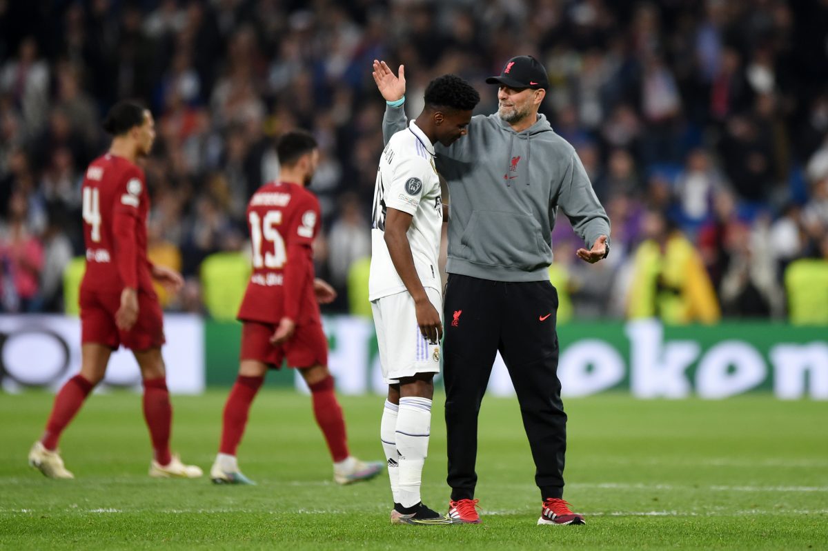 Aurelien Tchouameni of Real Madrid is embraced by Jurgen Klopp of Liverpool, during a UEFA Champions League match.