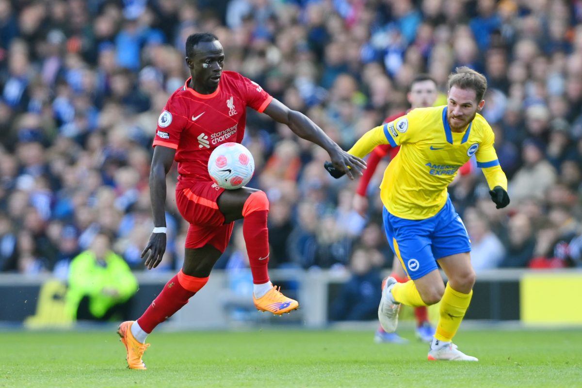 Sadio Mane of Liverpool battles for possession with Alexis Mac Allister of Brighton - March 2022. 