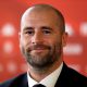 Monaco's Sporting Director Paul Mitchell smiles as he attends a press conference.