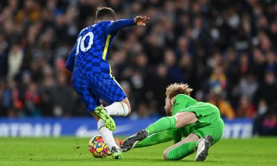 Caoimhin Kelleher of Liverpool makes a save against Christian Pulisic of Chelsea.