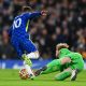 Caoimhin Kelleher of Liverpool makes a save against Christian Pulisic of Chelsea.