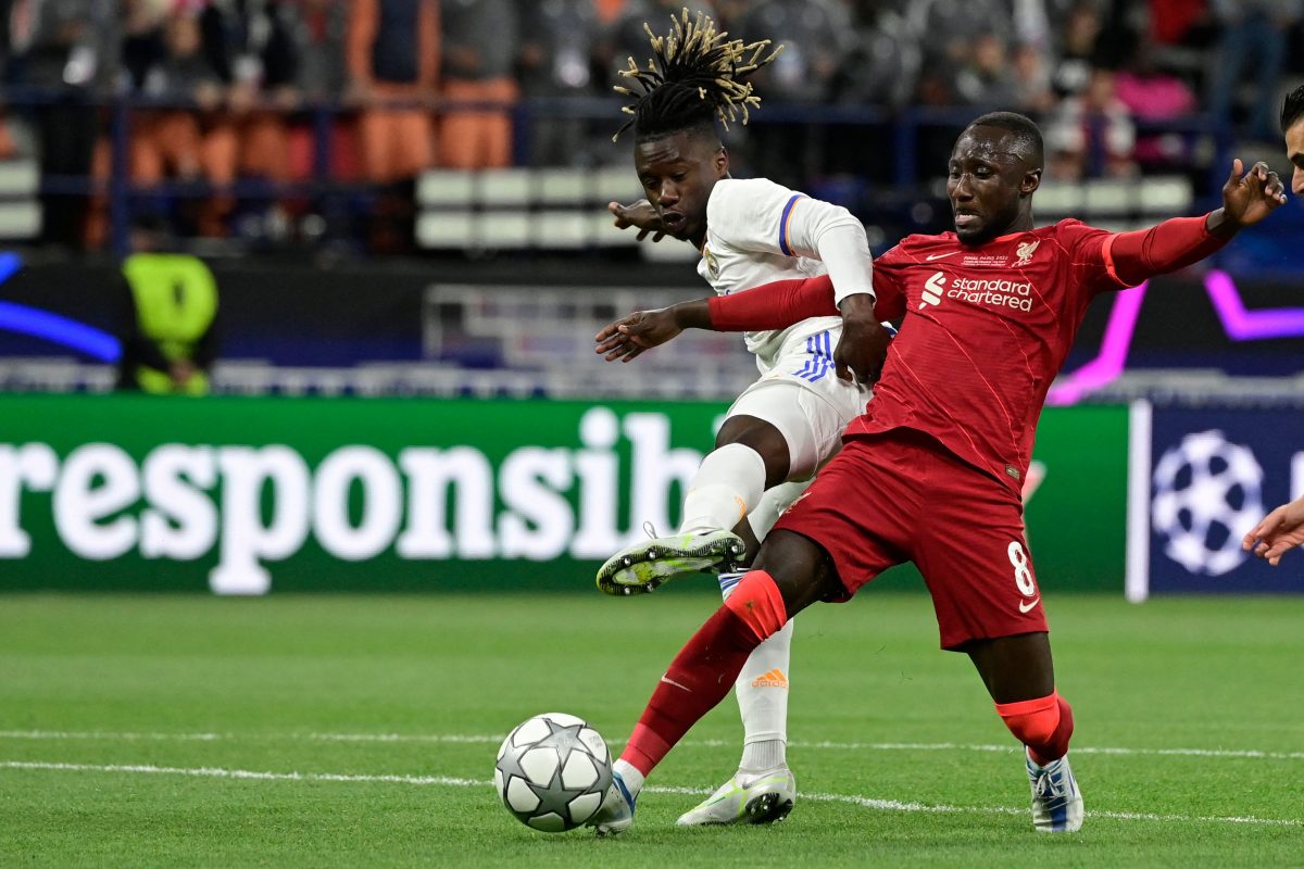 Liverpool's Guinean midfielder Naby Keita and Real Madrid's Eduardo Camavinga vie for the ball. 