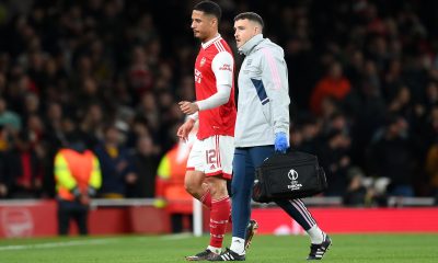 William Saliba of Arsenal leaves the pitch after picking up an injury.