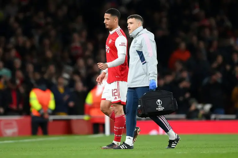 William Saliba of Arsenal leaves the pitch after picking up an injury.