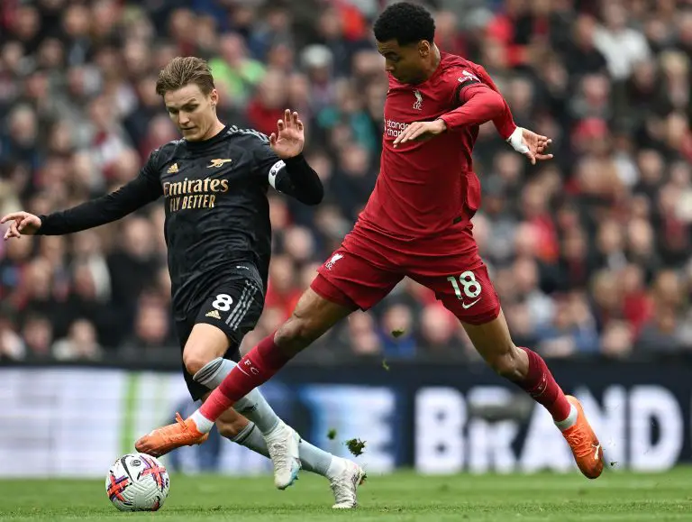 Arsenal's Norwegian midfielder Martin Odegaard (L) vies with Liverpool's Dutch striker Cody Gakpo.