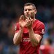 Liverpool's English midfielder James Milner applauds fans.