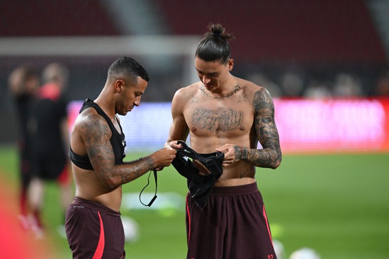 Liverpool's Thiago Alcantara (L) and Darwin Nunez (C) take part in a training session.