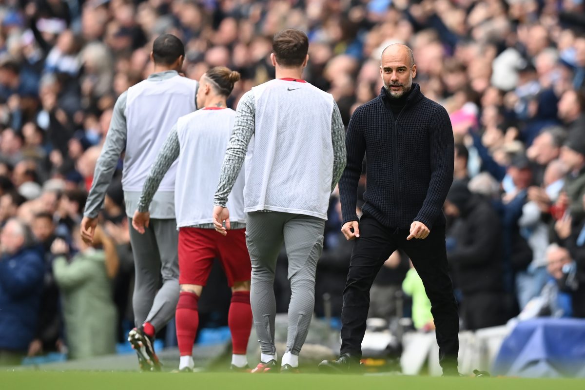 Manchester Ciy manager Pep Guardiola celebrates his side's equaliser in the face of Liverpool subsitutes.