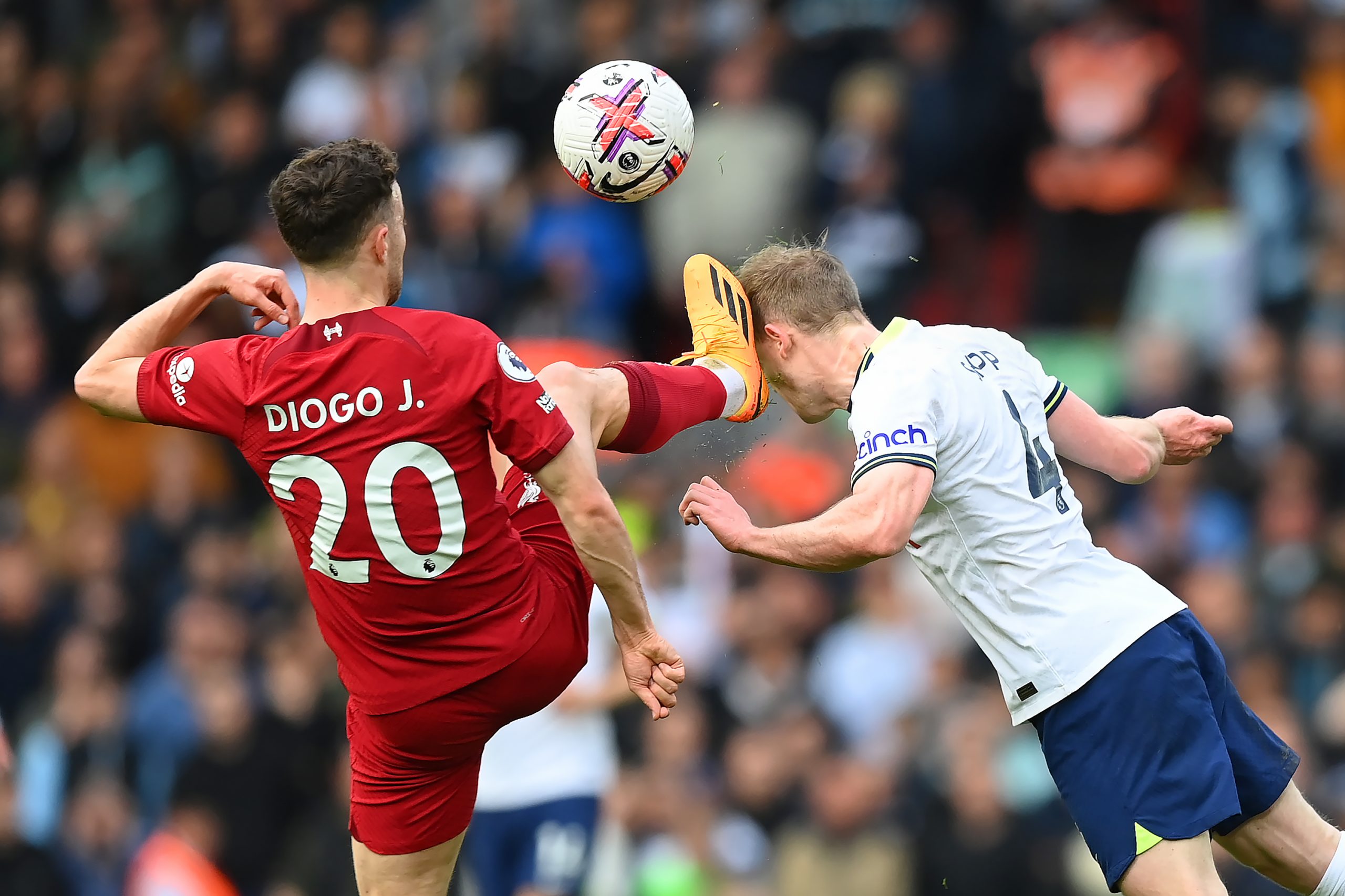 Diogo Jota of Liverpool clashes with Oliver Skipp of Tottenham Hotspur.