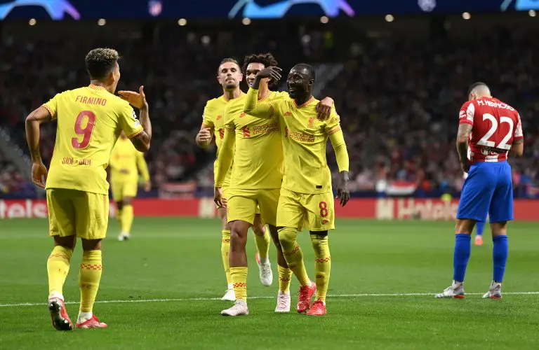 Naby Keita of Liverpool celebrates with Trent Alexander-Arnold and Roberto Firmino after scoring.