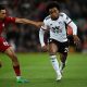 Liverpool's English defender Trent Alexander-Arnold (L) fights for the ball with Fulham's Brazilian midfielder Willian.