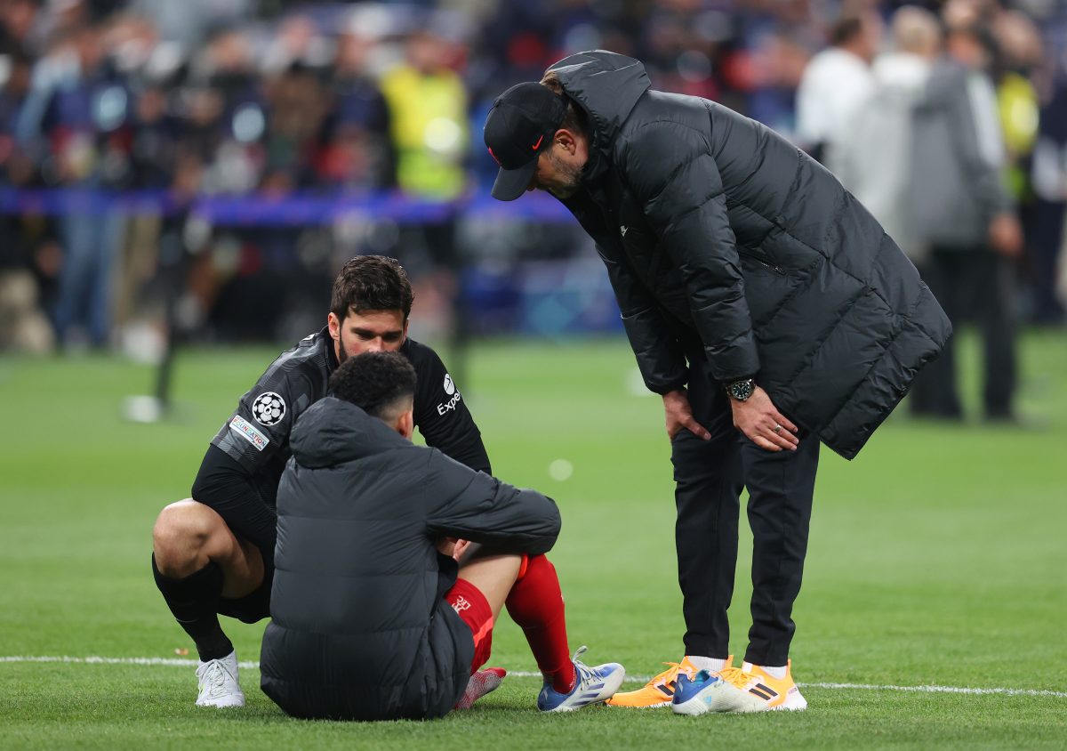 Jurgen Klopp and Alisson Becker embrace Luis Diaz of Liverpool after the 2022 UEFA Champions League final defeat against Real Madrid.
