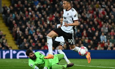 Fulham's Carlos Vinicius controls the ball as he fights for it with Liverpool's Brazilian goalkeeper Alisson Becker.