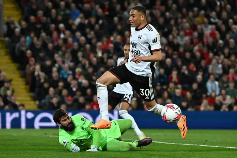 Fulham's Carlos Vinicius controls the ball as he fights for it with Liverpool's Brazilian goalkeeper Alisson Becker.