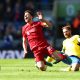 Diogo Jota of Liverpool is tackled by Alexis Mac Allister of Brighton.