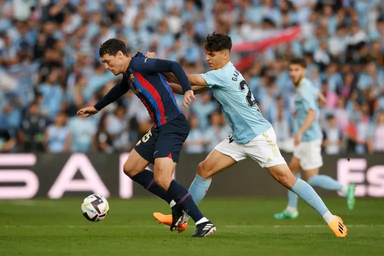 Andreas Christensen of FC Barcelona is challenged by Gabri Veiga of RC Celta.