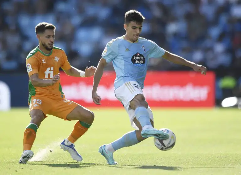 Celta Vigo's Gabriel Veiga (R) is challenged by Real Betis' Spanish defender Alex Moreno.