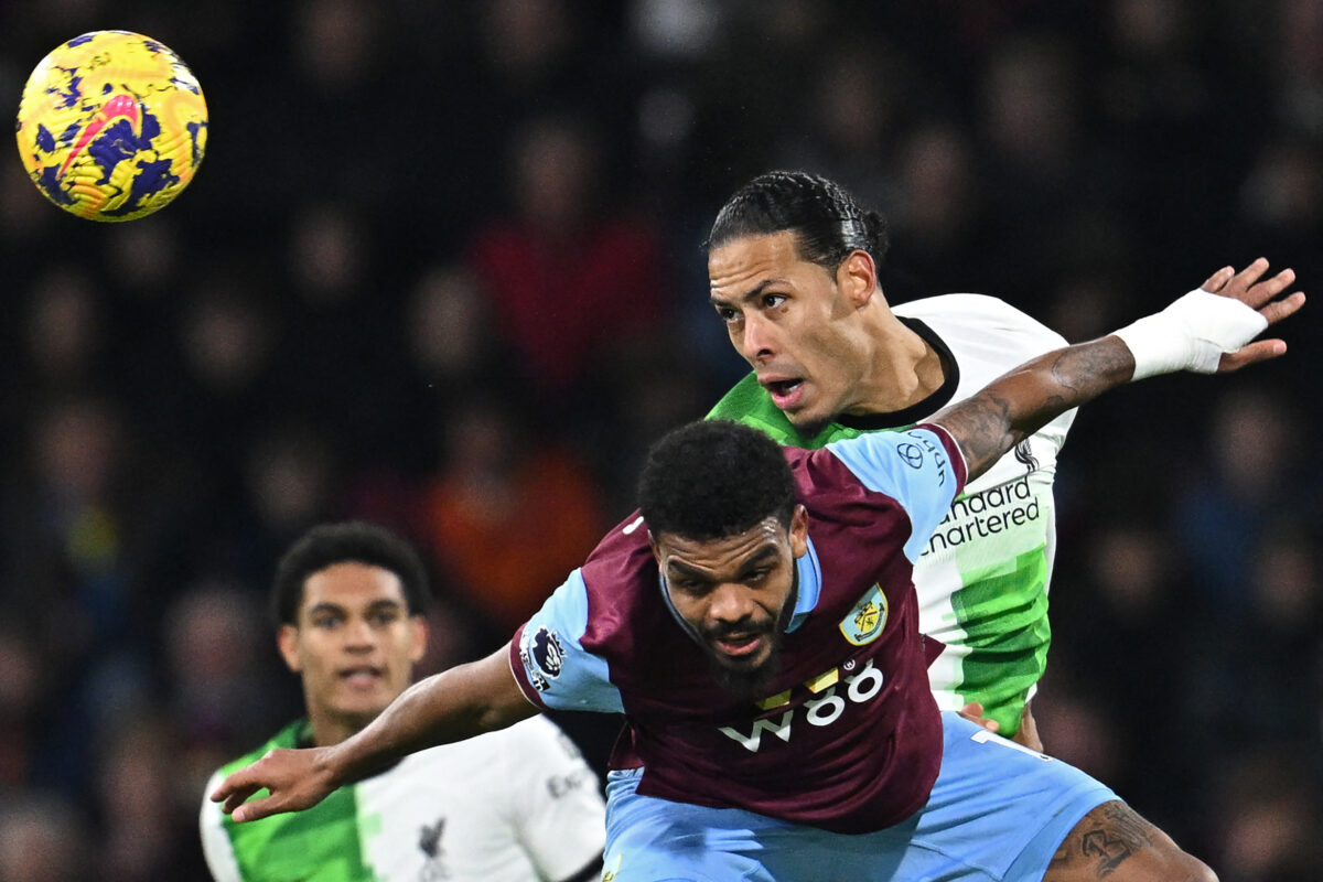Liverpool's Dutch defender #04 Virgil van Dijk (R) vies with Burnley's South African striker #17 Lyle Foster (C) during the English Premier League football match between Burnley and Liverpool at Turf Moor in Burnley, north-west England on December 26, 2023. (Photo by Paul ELLIS / AFP) / RESTRICTED TO EDITORIAL USE. No use with unauthorized audio, video, data, fixture lists, club/league logos or 'live' services. Online in-match use limited to 120 images. An additional 40 images may be used in extra time. No video emulation. Social media in-match use limited to 120 images. An additional 40 images may be used in extra time. No use in betting publications, games or single club/league/player publications. /  (Photo by PAUL ELLIS/AFP via Getty Images)