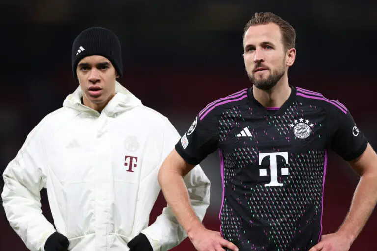 MANCHESTER, ENGLAND - DECEMBER 12: Harry Kane and Jamal Musiala of Bayern Munich look towards the travelling supporters at full-time following the UEFA Champions League match between Manchester United and FC Bayern München at Old Trafford on December 12, 2023 in Manchester, England. (Photo by Michael Steele/Getty Images)