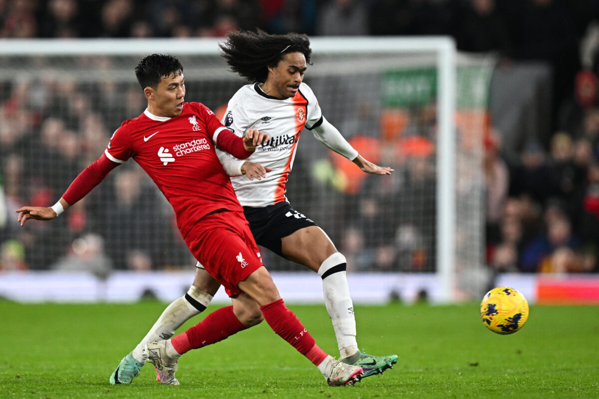 Liverpool's Japanese midfielder #03 Wataru Endo (L) fights for the ball with Luton Town's English midfielder #06 Ross Barkley during the English Premier League football match between Liverpool and Luton Town at Anfield in Liverpool, north west England on February 21, 2024. (Photo by Paul ELLIS / AFP) / RESTRICTED TO EDITORIAL USE. No use with unauthorized audio, video, data, fixture lists, club/league logos or 'live' services. Online in-match use limited to 120 images. An additional 40 images may be used in extra time. No video emulation. Social media in-match use limited to 120 images. An additional 40 images may be used in extra time. No use in betting publications, games or single club/league/player publications. /  (Photo by PAUL ELLIS/AFP via Getty Images)