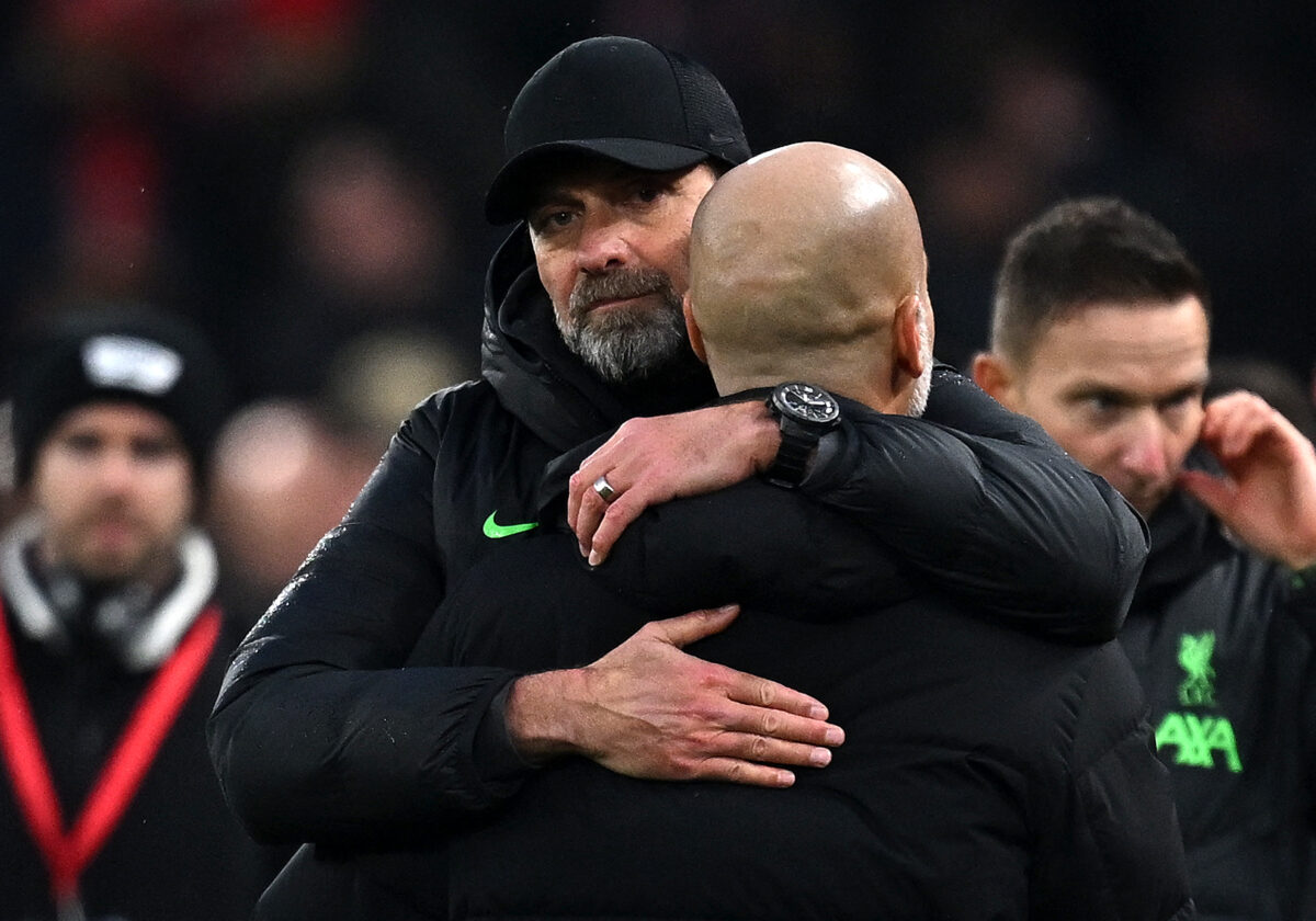 Liverpool's German manager Jurgen Klopp embraces Manchester City's Spanish manager Pep Guardiola  (Photo by Paul ELLIS / AFP)