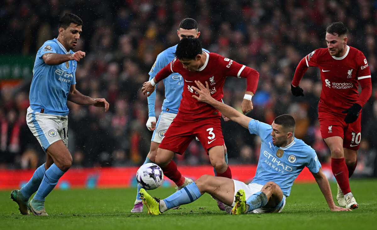 Manchester City's Croatian midfielder #08 Mateo Kovacic (2R) vies with Liverpool's Japanese midfielder #03 Wataru Endo (C) during the English Premier League football match between Liverpool and Manchester City at Anfield in Liverpool, north west England on March 10, 2024. (Photo by Paul ELLIS / AFP) / RESTRICTED TO EDITORIAL USE. No use with unauthorized audio, video, data, fixture lists, club/league logos or 'live' services. Online in-match use limited to 120 images. An additional 40 images may be used in extra time. No video emulation. Social media in-match use limited to 120 images. An additional 40 images may be used in extra time. No use in betting publications, games or single club/league/player publications. /  (Photo by PAUL ELLIS/AFP via Getty Images)