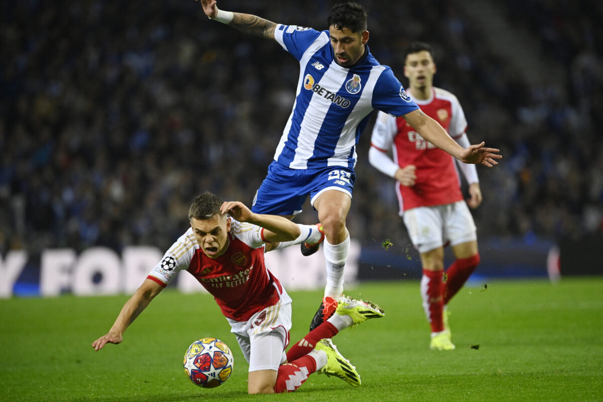 FC Porto's Argentine midfielder #22 Alan Varela (TOP) vies with Arsenal's Belgian midfielder #19 Leandro Trossard during the UEFA Champions League last 16 first leg football match between FC Porto and Arsenal FC at the Dragao stadium in Porto on February 21, 2024. (Photo by MIGUEL RIOPA / AFP) (Photo by MIGUEL RIOPA/AFP via Getty Images)