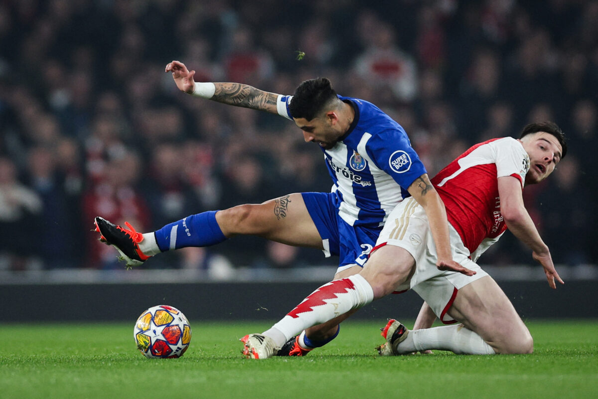Arsenal's English midfielder #41 Declan Rice (R) fights for the ball with Porto's Argentinian midfielder #22 Alan Varela during the UEFA Champions League last 16 second leg football match between Arsenal and Porto FC at the Arsenal Stadium in north London, on March 12, 2024. (Photo by Adrian DENNIS / AFP) (Photo by ADRIAN DENNIS/AFP via Getty Images)