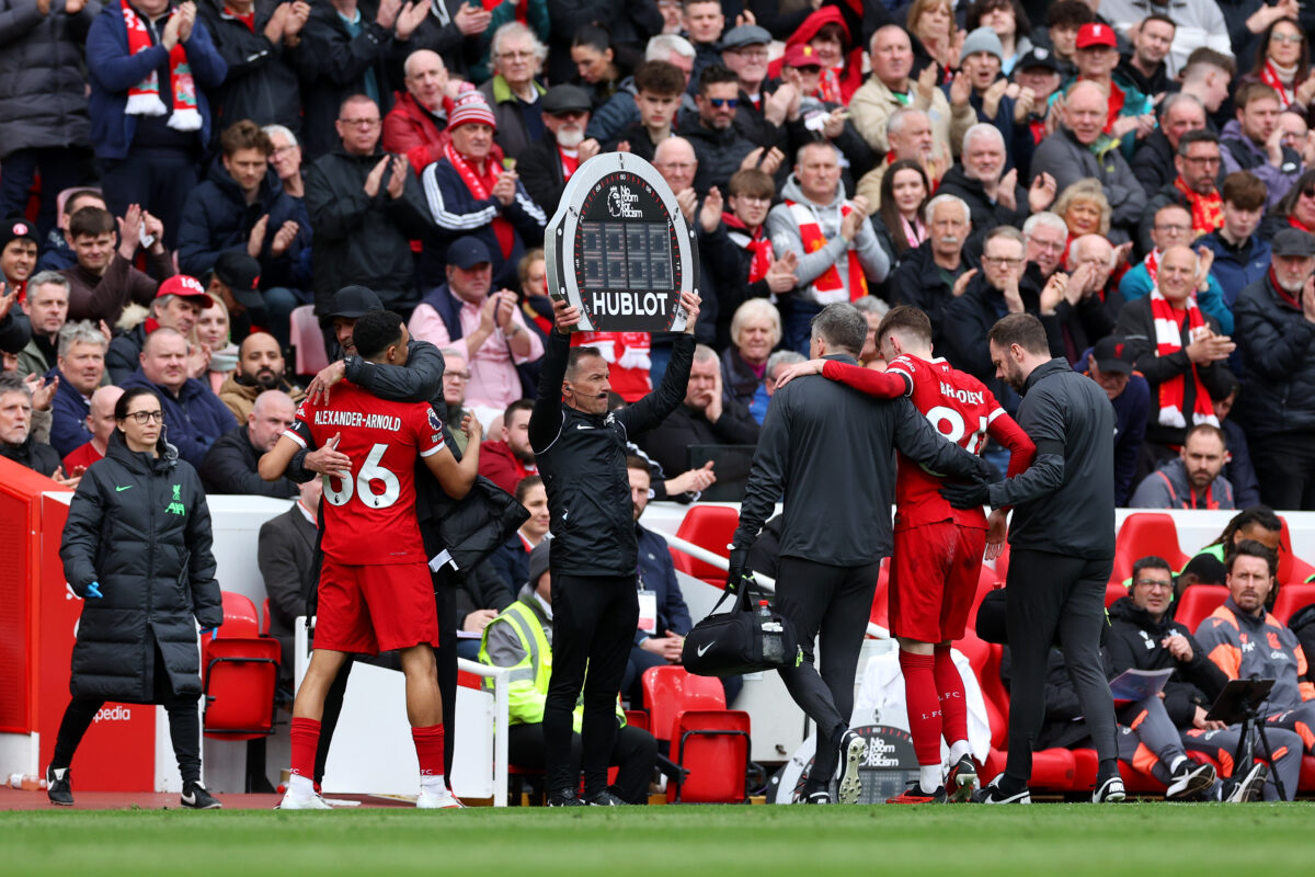 LIVERPOOL, ENGLAND - APRIL 14: Conor Bradley of Liverpool leaves the pitch injured as Trent Alexander-Arnold of Liverpool is embraced by Jurgen Klopp, Manager of Liverpool, prior to being substituted on during the Premier League match between Liverpool FC and Crystal Palace at Anfield on April 14, 2024 in Liverpool, England. (Photo by Michael Steele/Getty Images)