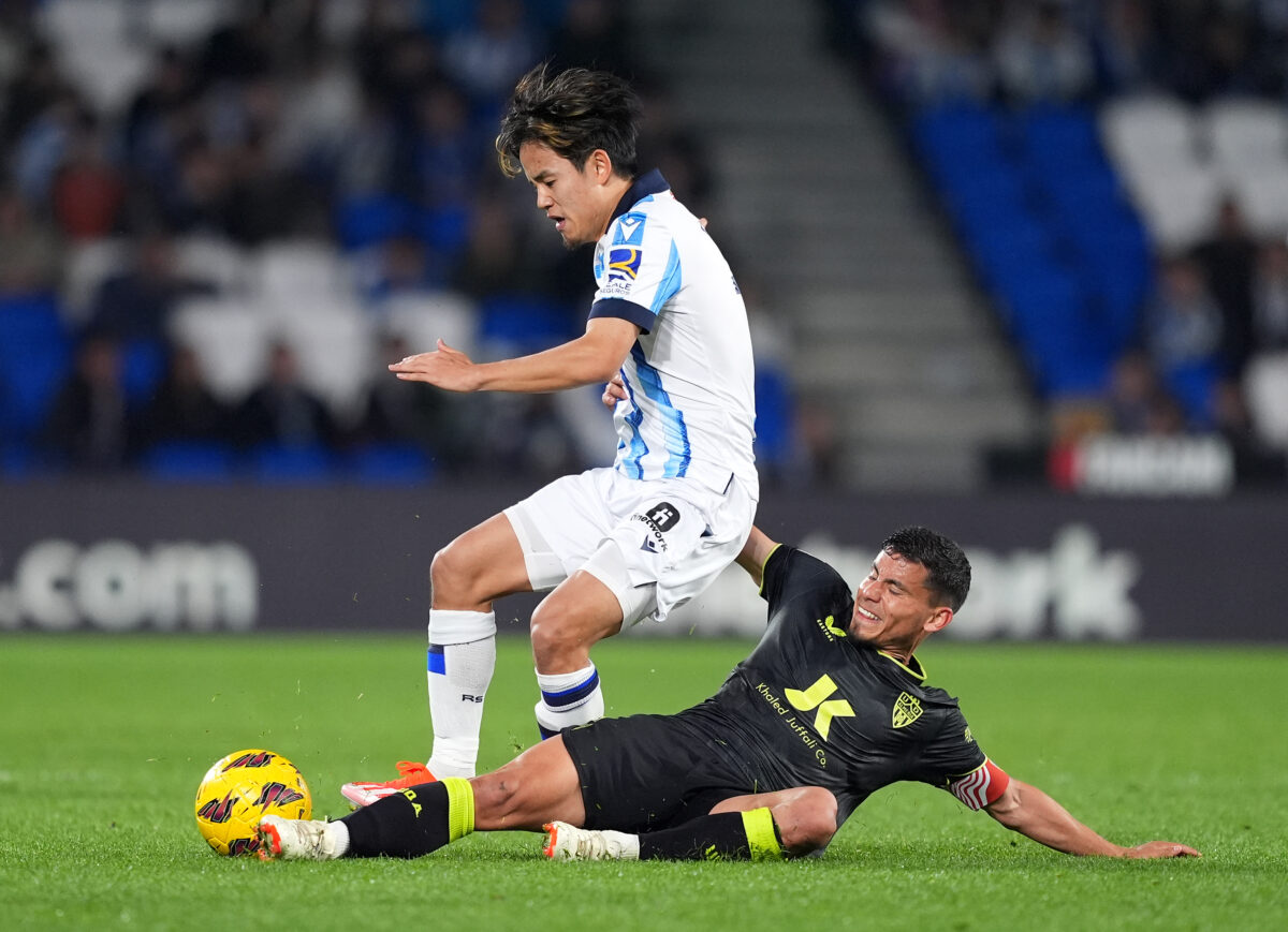 SAN SEBASTIAN, SPAIN - APRIL 14: Takefusa Kubo of Real Sociedad is challenged by Lucas Robertone of UD Almeria during the LaLiga EA Sports match between Real Sociedad and UD Almeria at Reale Arena on April 14, 2024 in San Sebastian, Spain. (Photo by Juan Manuel Serrano Arce/Getty Images)