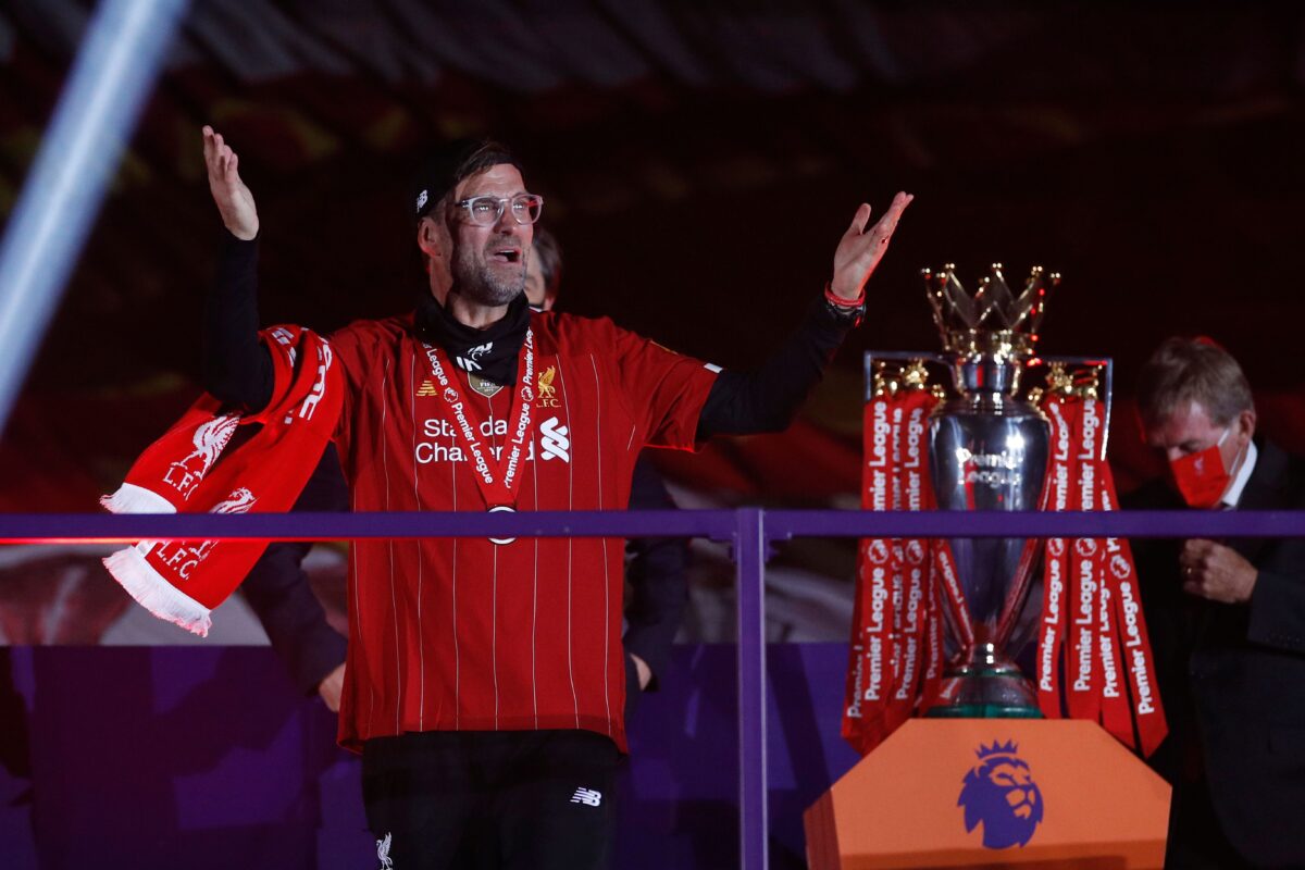 Liverpool's German manager Jurgen Klopp recieves his medal next to the Premier League trophy during the presentation following the English Premier League football match between Liverpool and Chelsea at Anfield in Liverpool, north west England on July 22, 2020. - Liverpool on Wednesday lifted the Premier League trophy at the famous Kop stand at Anfield after their final home game of the season. With no fans able to attend due to the COVID-19 coronavirus pandemic, Liverpool said the idea for the trophy lift was to honour the club's fans, but Liverpool manager Jurgen Klopp urged fans to respect social distancing measures, after thousands gathered around the club's stadium and in the city centre following their coronation as champions last month. (Photo by PHIL NOBLE / POOL / AFP) / RESTRICTED TO EDITORIAL USE. No use with unauthorized audio, video, data, fixture lists, club/league logos or 'live' services. Online in-match use limited to 120 images. An additional 40 images may be used in extra time. No video emulation. Social media in-match use limited to 120 images. An additional 40 images may be used in extra time. No use in betting publications, games or single club/league/player publications. /  (Photo by PHIL NOBLE/POOL/AFP via Getty Images)