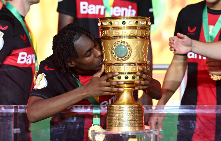 BERLIN, GERMANY - MAY 25: Jeremie Frimpong of Bayer 04 Leverkusen kisses the DFB-Pokal Trophy after his team's victory in the DFB Cup 2023/24 final match between 1. FC Kaiserslautern and Bayer 04 Leverkusen at Olympiastadion on May 25, 2024 in Berlin, Germany. (Photo by Stuart Franklin/Getty Images)