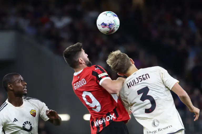 AC Milan's Olivier Giroud (C) and AS Roma's Dean Huijsen fight for the ball during a friendly match between AC Milan and AS Roma at the Perth Rectangular Stadium in Perth on May 31, 2024. (Photo by COLIN MURTY / AFP) / -- IMAGE RESTRICTED TO EDITORIAL USE - STRICTLY NO COMMERCIAL USE -- (Photo by COLIN MURTY/AFP via Getty Images)