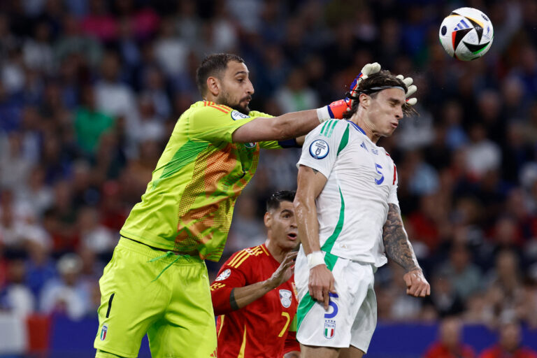 Italy's goalkeeper #01 Gianluigi Donnarumma (L) saves the ball next to Italy's defender #05 Riccardo Calafiori during the UEFA Euro 2024 Group B football match between Spain and Italy at the Arena AufSchalke in Gelsenkirchen on June 20, 2024. (Photo by KENZO TRIBOUILLARD / AFP) (Photo by KENZO TRIBOUILLARD/AFP via Getty Images)