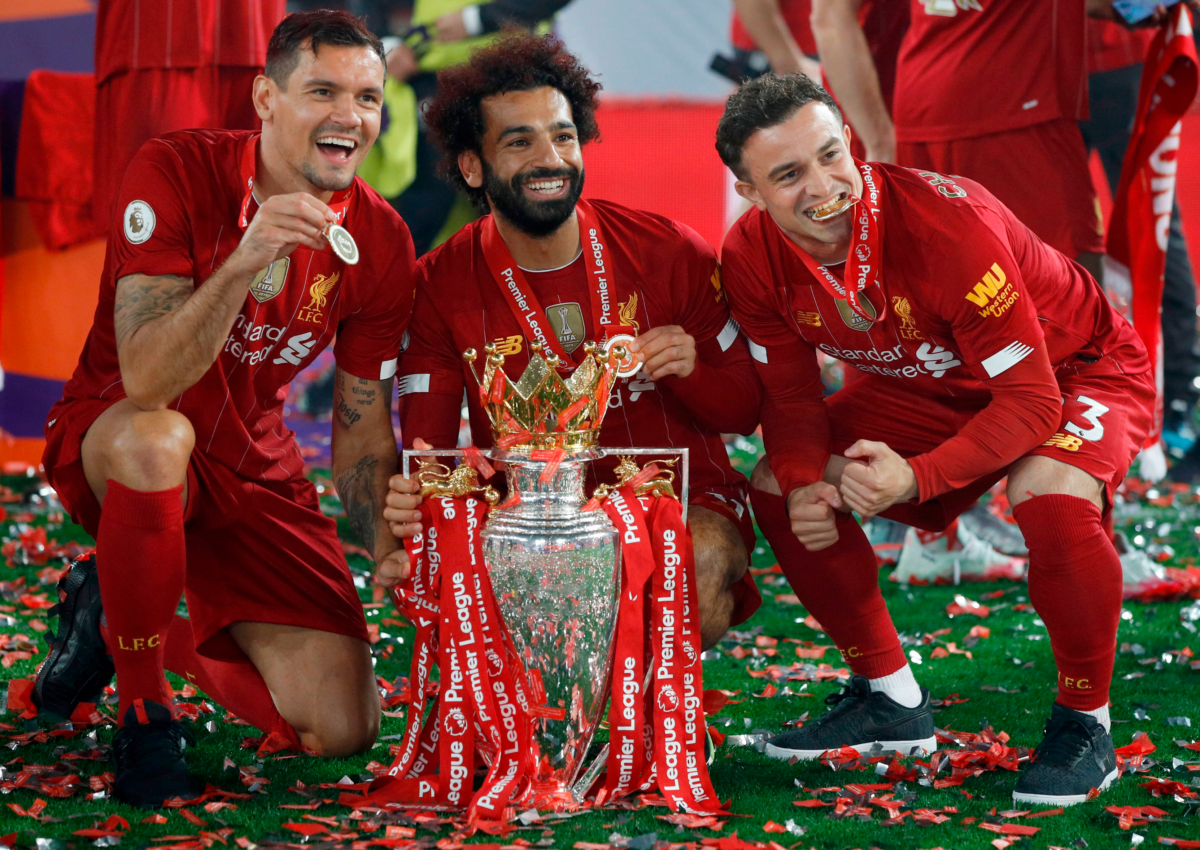 Dejan Lovren, midfielder Mohamed Salah, Xherdan Shaqiri pose with the Premier League trophy (Photo by PHIL NOBLE/POOL/AFP via Getty Images)